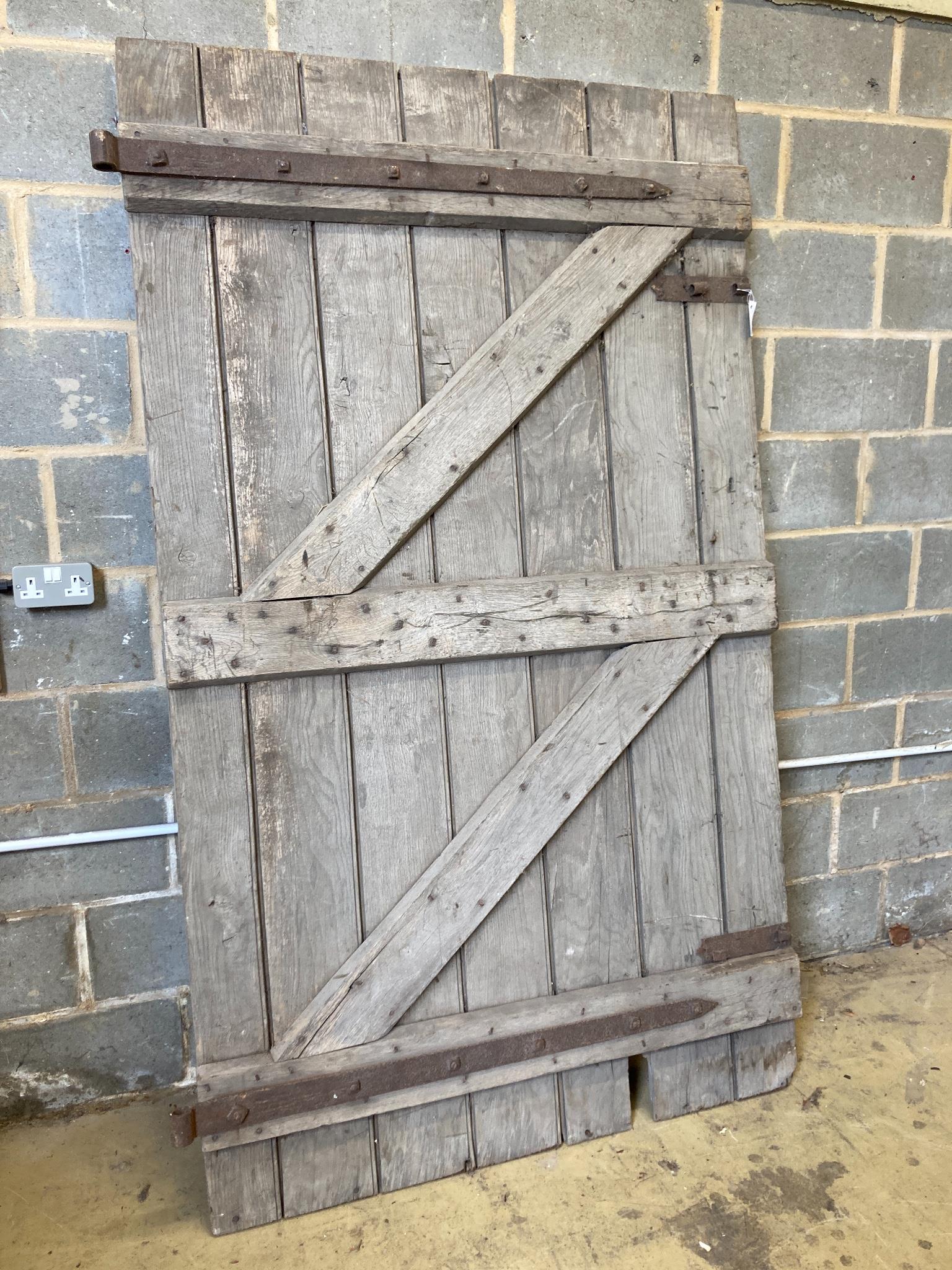A 19th century oak barn door, width 124cm, height 213cm